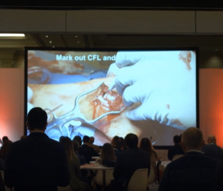 A group of people watching a presentation.