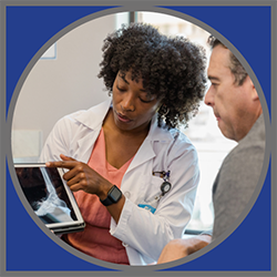 A doctor looking at a tablet.